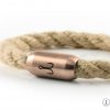 Close up detail fisherman hook engraving on stainless steel magnetic clasp rose gold, natural rope twisted