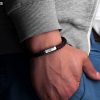 Bracelet from sailing rope with engraving of Fischers Fritze on wrist, Mackerel navy blue dark red, hand in trouser pocket